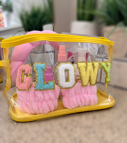 Clear makeup bag with pink fluffy pouches and 'GLOW' text in colorful letters.