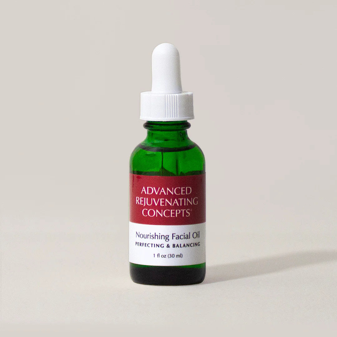 Nourishing Facial Oil in a green glass bottle with a dropper, labeled "Advanced Rejuvenating Concepts.