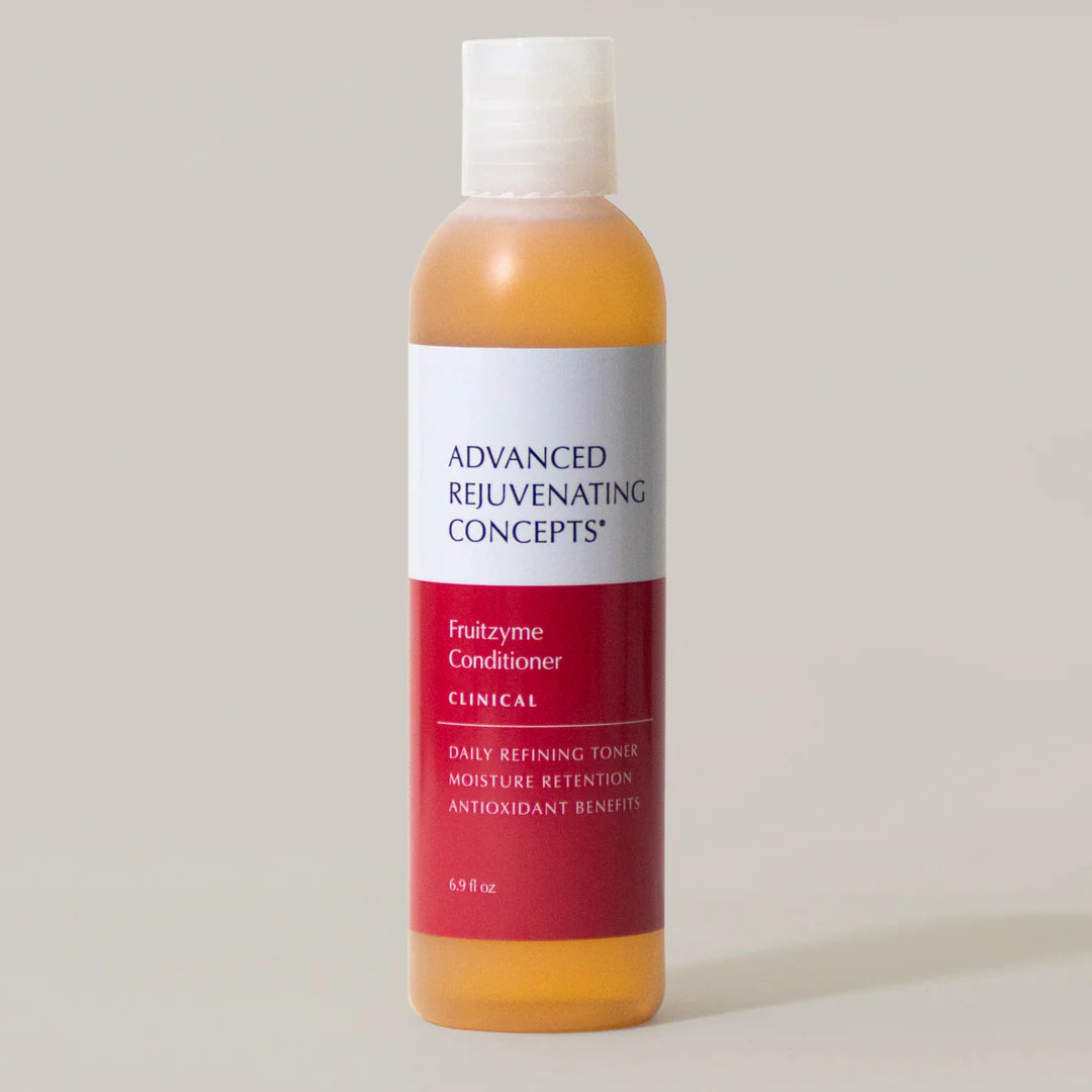 Fruitzyme Conditioner in a clear bottle with a red label, designed for moisture retention and antioxidant benefits.