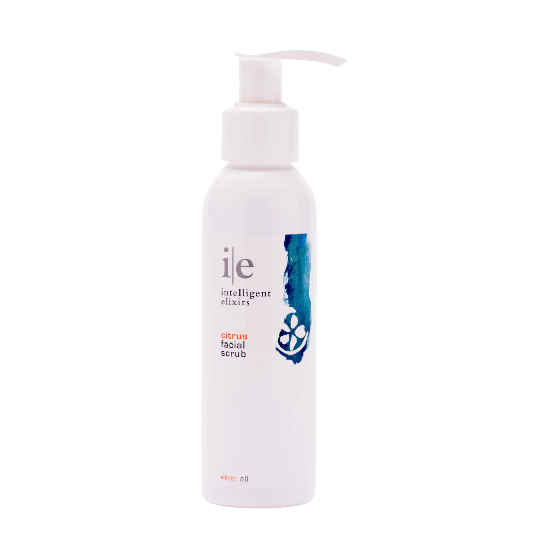 Citrus facial scrub in a white bottle with a pump, featuring a colorful label design.
