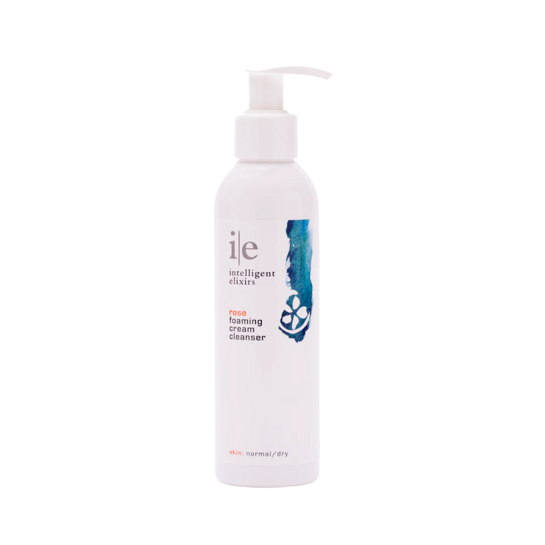 Rose Foaming Cream Cleanser in a white bottle with a pump, designed for normal to dry skin.
